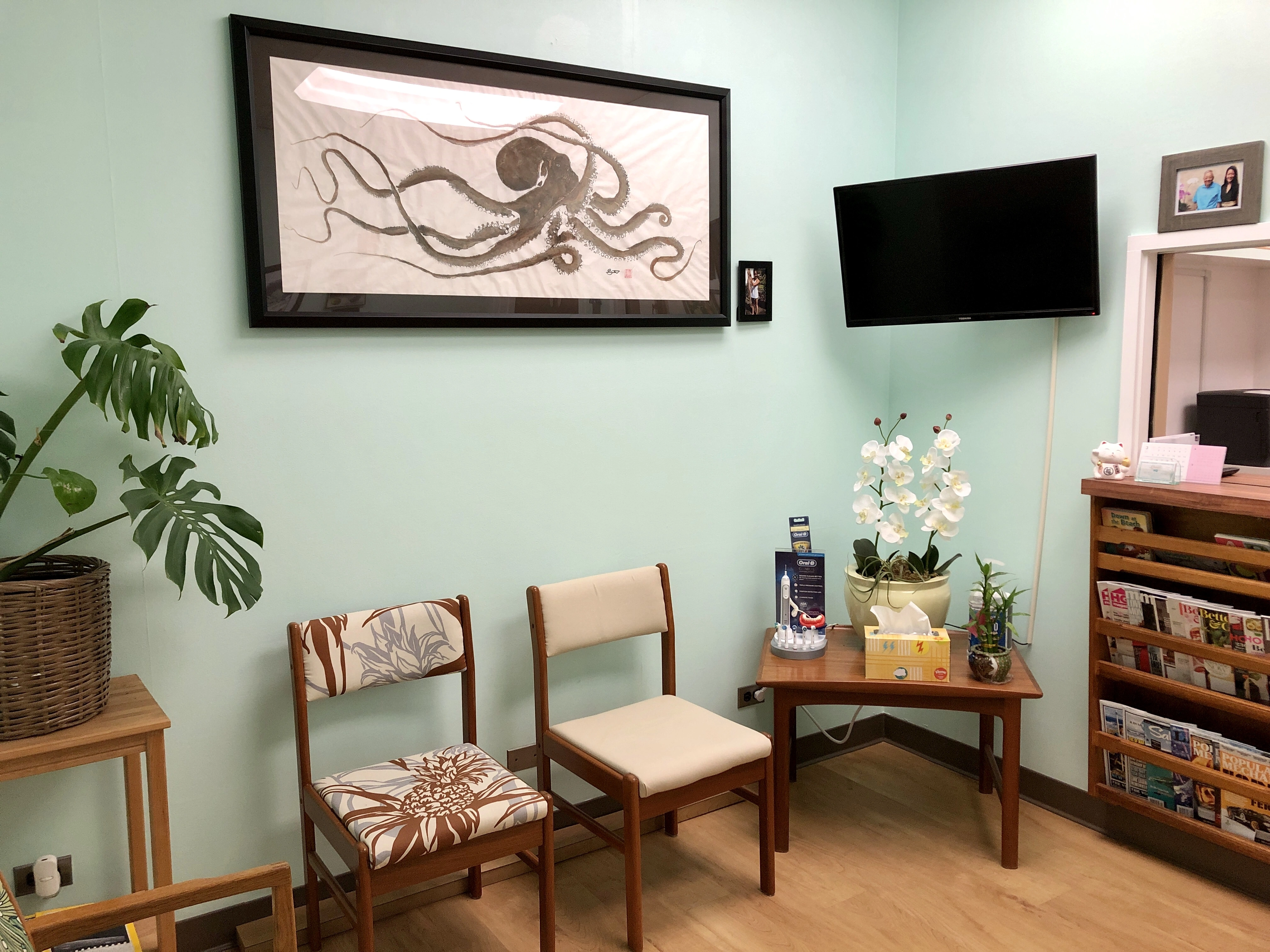 The waiting room at Dr. Keri Wong’s Honolulu office, with orchids and upholstered chairs